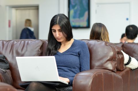 Employers sitting at desk with employees looking at a computer screen